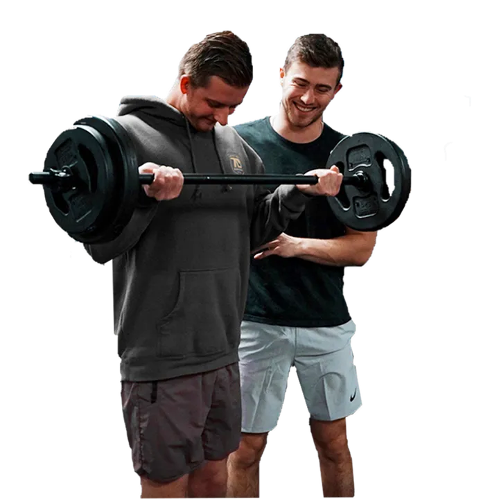 Devon coaching a client through a barbell exercise